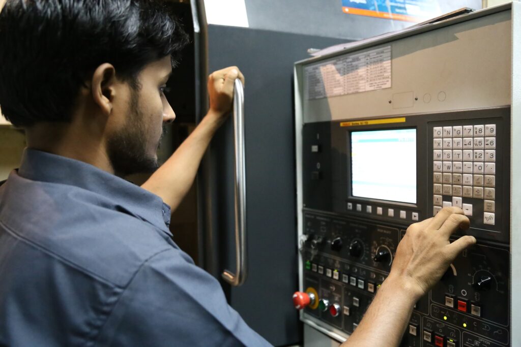 Worker using an Industry 4.0 CNC machine interface