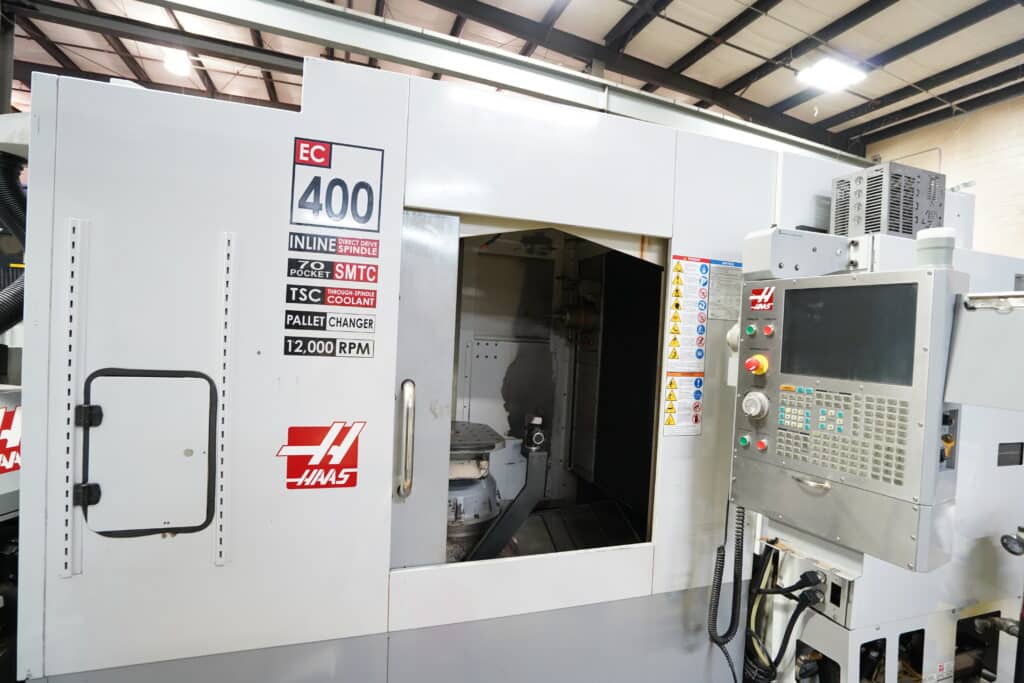 a large haas cnc machine with a door open